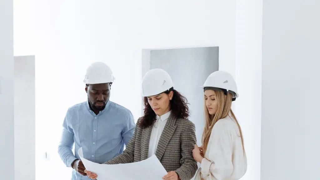 Contractor SEO example: team in hard hats reviewing plans inside a newly built home