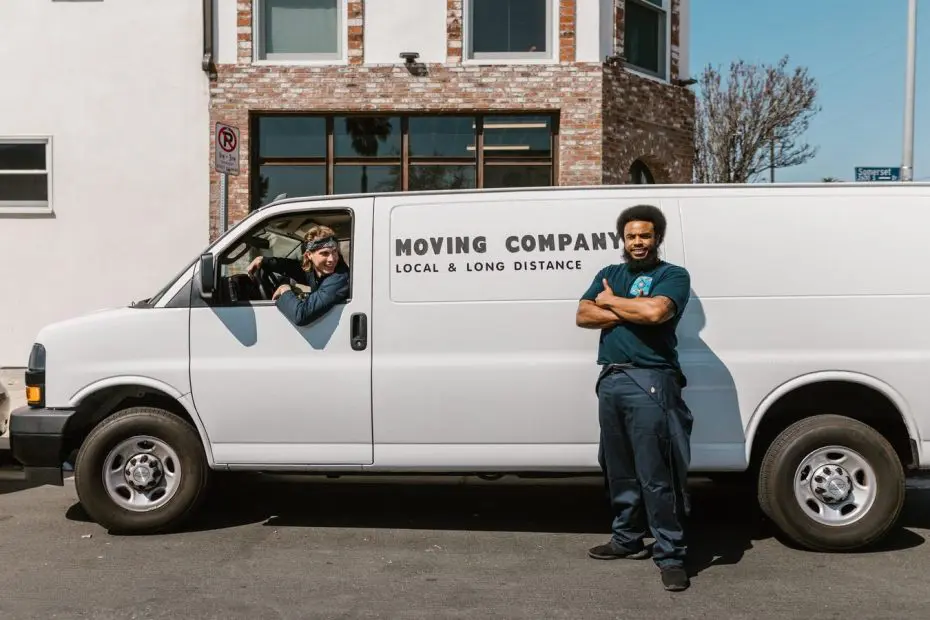 Moving company SEO: mover standing beside a white moving company van