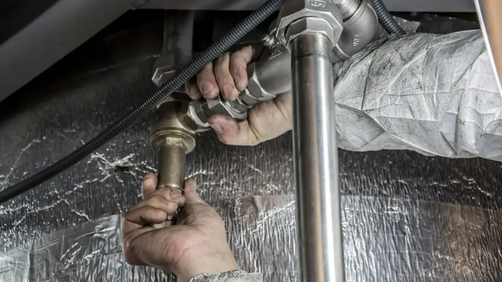 Plumber SEO: plumber's hands installing pipe fittings during a repair