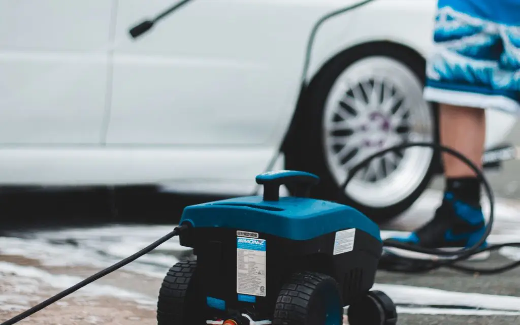 Pressure washer in use on a driveway