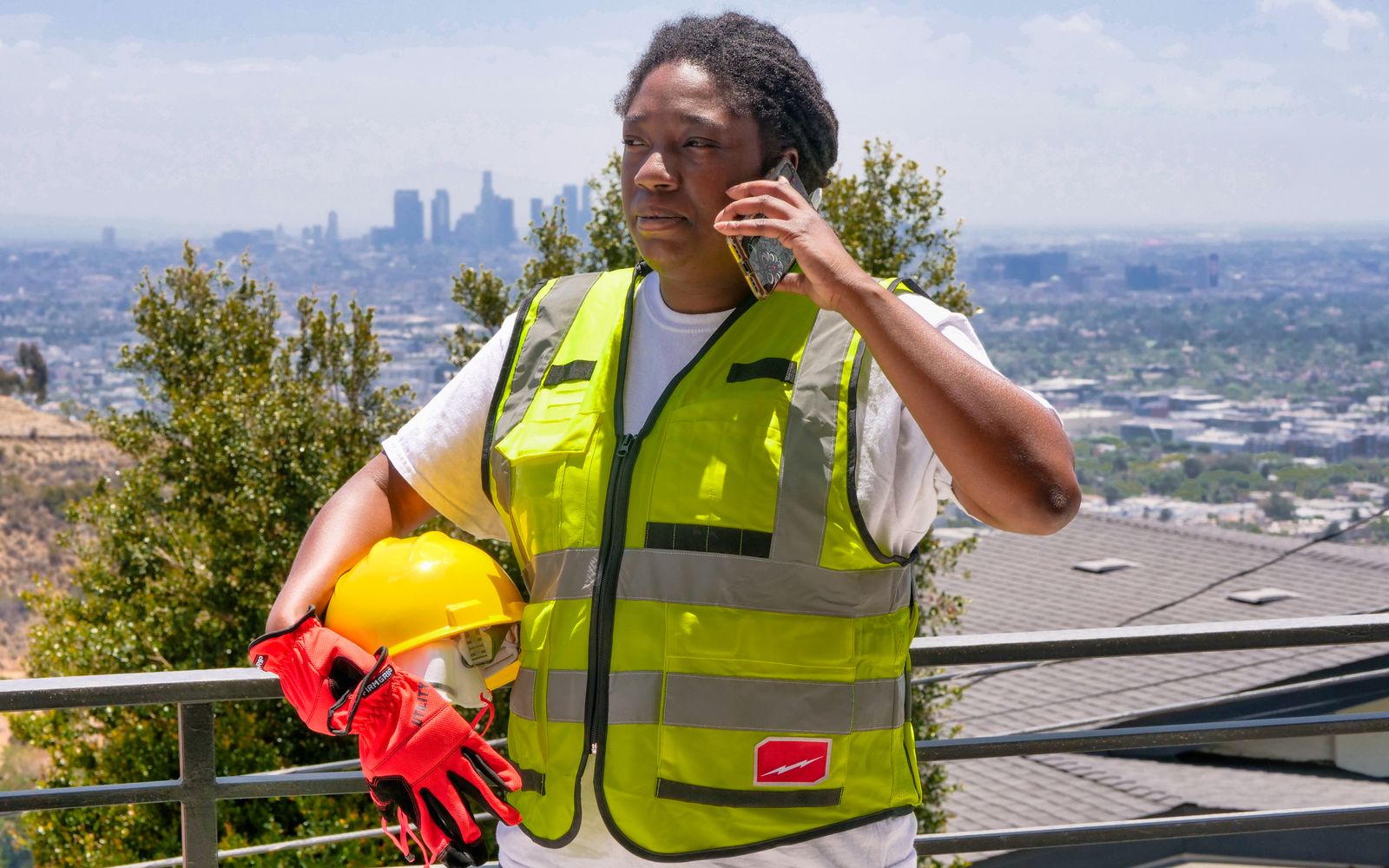 Contractor checking a customer message on a phone at a job site