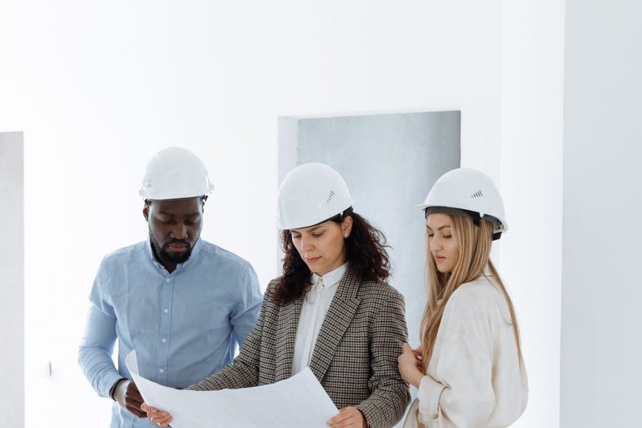 Contractor SEO example: team in hard hats reviewing plans inside a newly built home